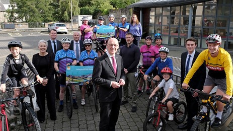 Members of the South of Scotland Cycling Partnership with Deputy First Minister John Swinney, and local mountain bikers, members of Hawick Belles Cycling Club and junior cyclists from Trinity Primary School for the launch of the South of Scotland Cycling Partnership Strategy in Hawick.