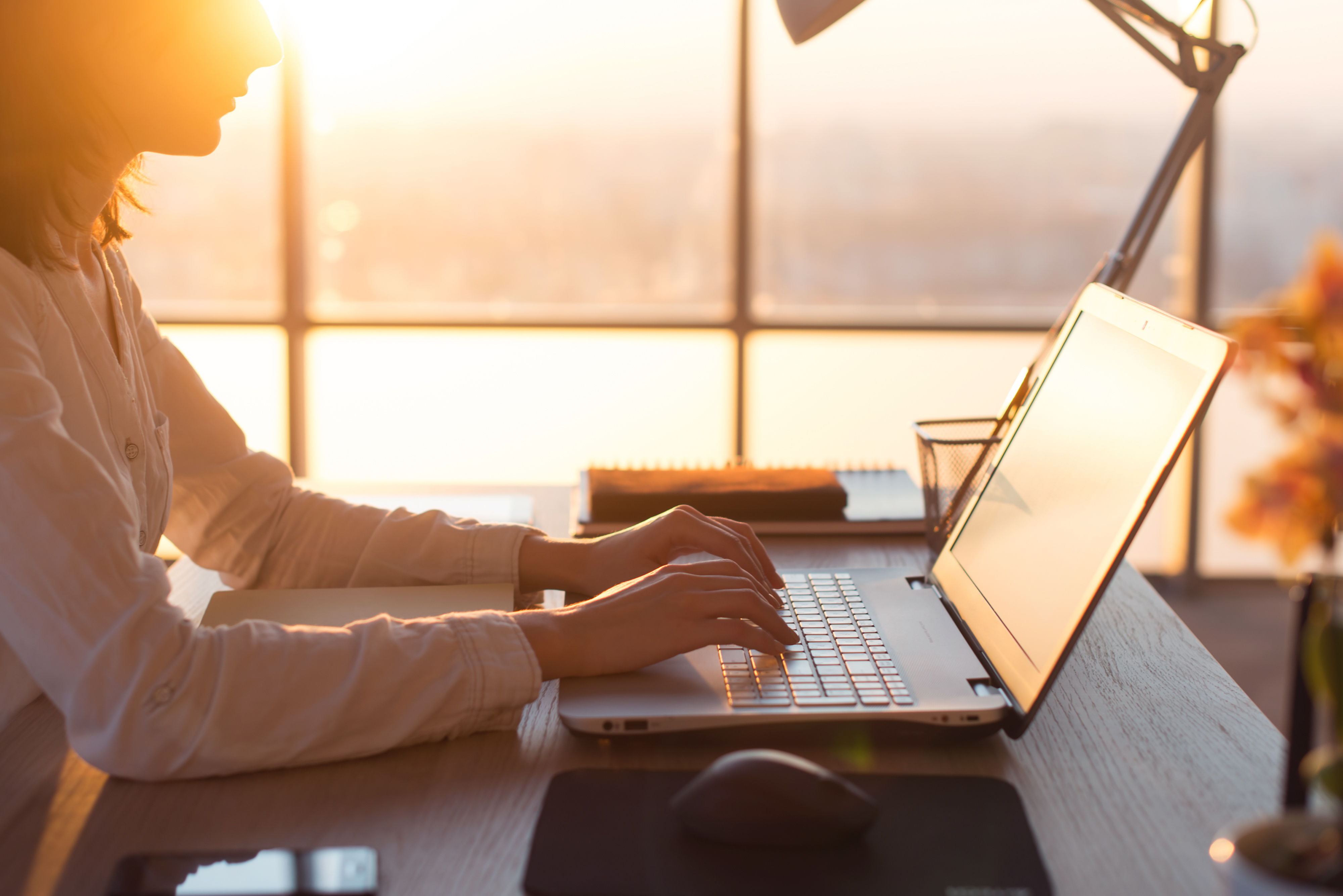 Woman typing on laptop at desk