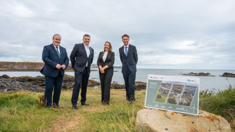 four people stand alongside Eyemouth Harbour Masterplan document