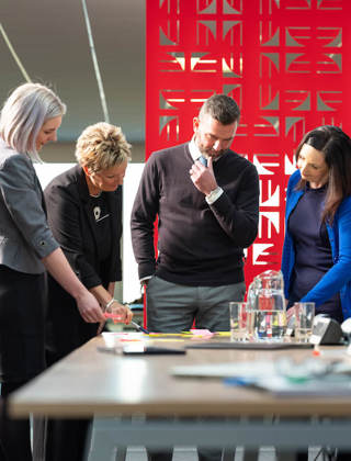 photo of people standing and working together