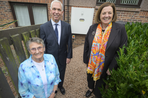 Muriel, Lawrence Fagg and Julia Mulloy outside Muriel's home in front of the Kight Powerhub battery