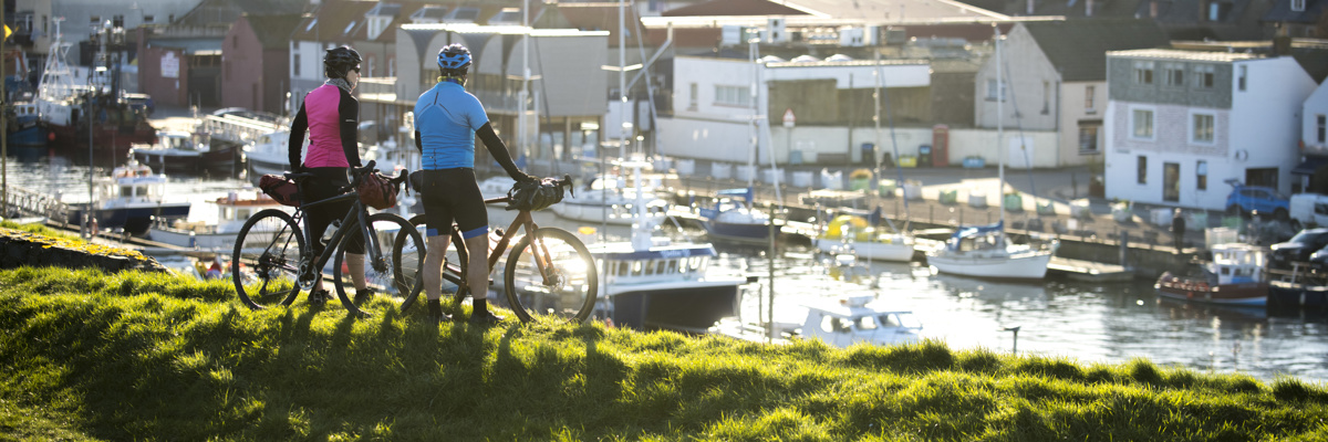 Two cyclists overlooking harbour