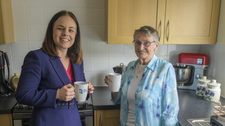 Kate Forbes and Muriel Allison with cups of tea