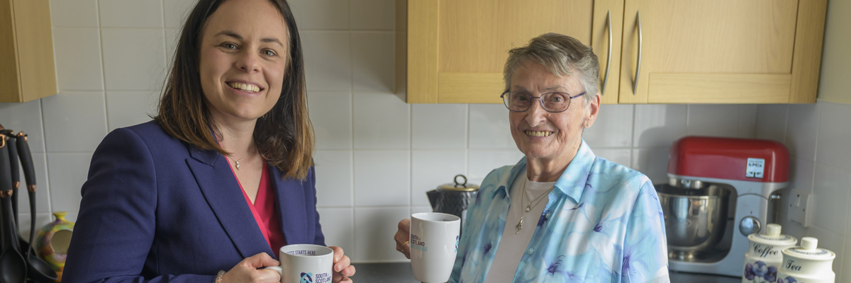 Kate Forbes and Muriel Allison with cups of tea