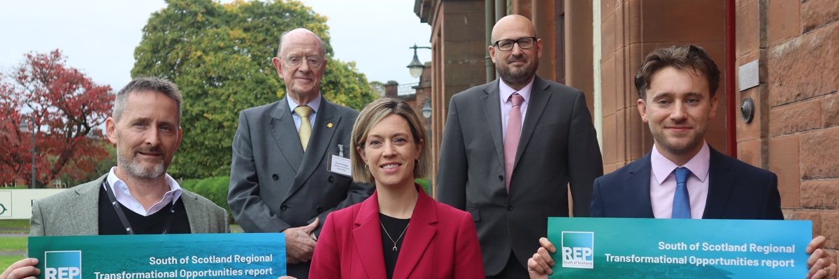 People holding signs for Regional Transformational Opportunities report