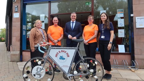 Lena Scoular of SOSE, George Crow of Hike & Bike Hub, Business Minister Tom Arthur, Angela Crow of Hike & Bike Hub and SBC's Alex Fleming-Knox standing behind a bike
