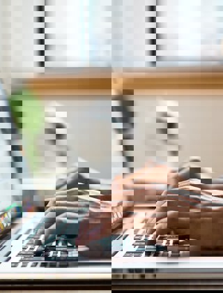 Person typing on a laptop