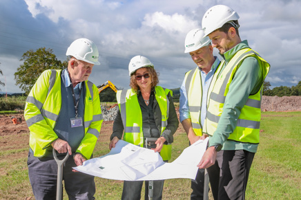 Four people look at plans for new Pickstock Telford Ecclefechan facility