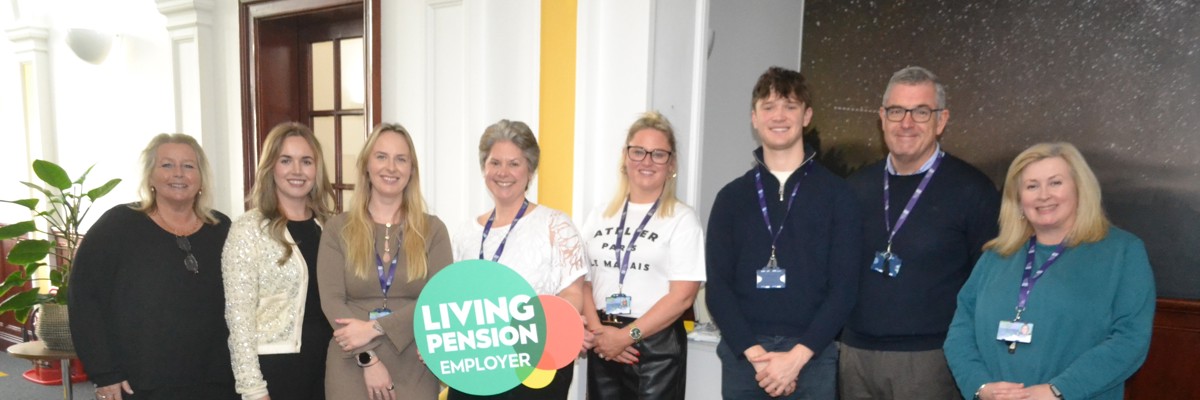 Staff with Living Pension sign